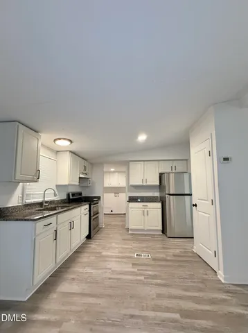 a kitchen with a sink a stove and refrigerator