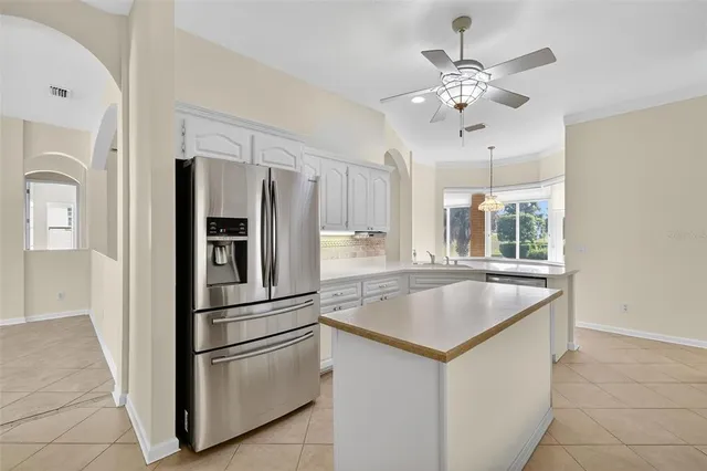 a kitchen with kitchen island granite countertop appliances cabinets and a counter top space