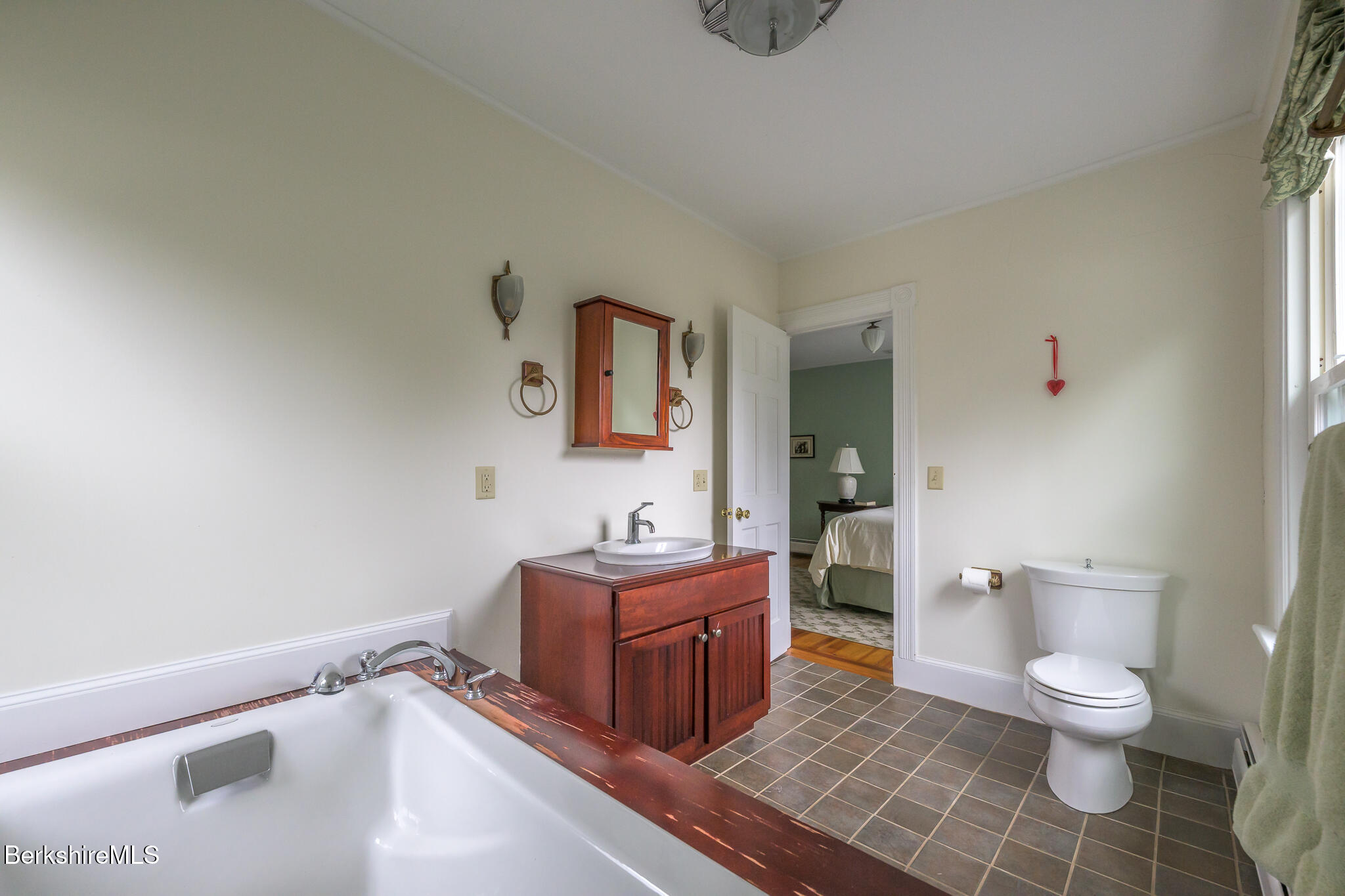 11 Sergeant Street Stockbridge, MA 01262 - Photo 32 of 52 a spacious bathroom with a toilet sink and mirror