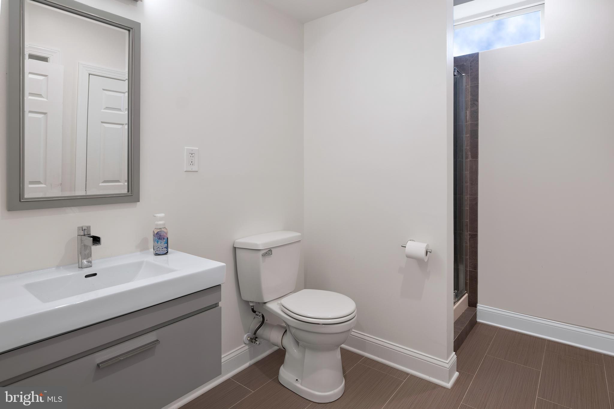 22 Liam Place Skillman, NJ 08558 - Photo 12 of 13 a bathroom with a toilet a sink and mirror