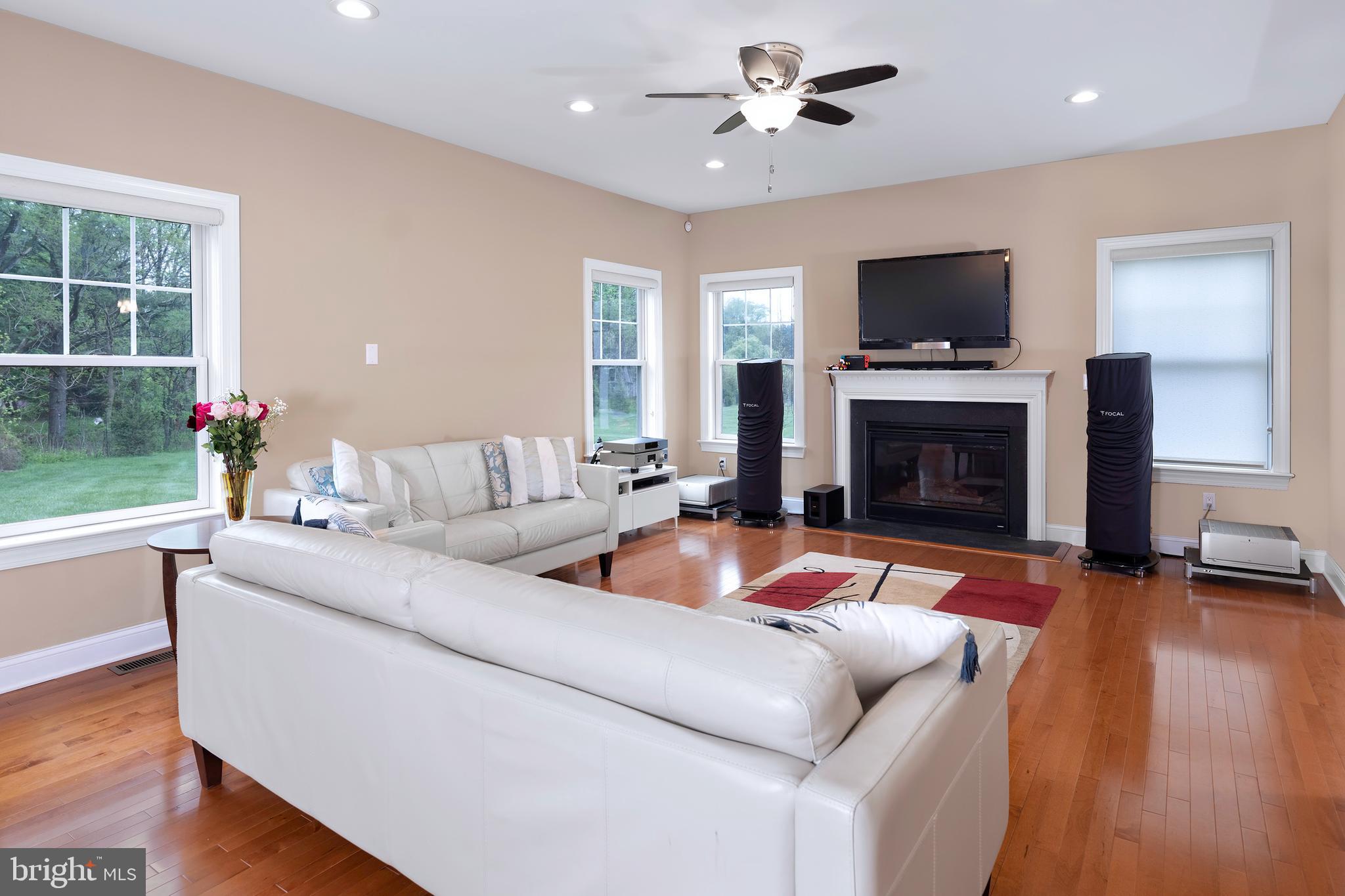 22 Liam Place Skillman, NJ 08558 - Photo 3 of 13 a living room with furniture flat screen tv and a fireplace