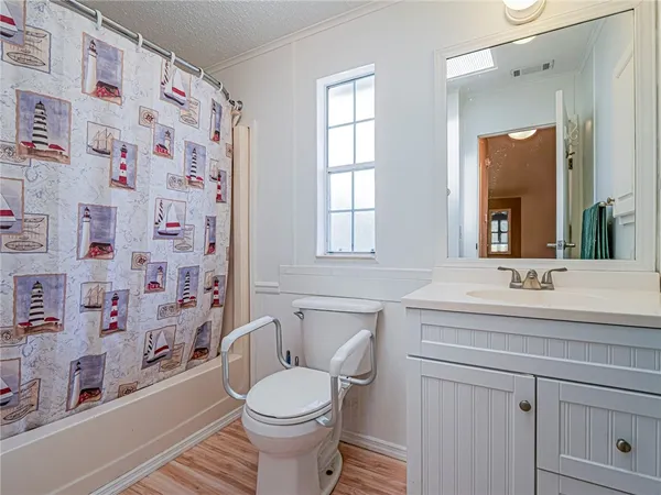 a dining room with furniture a chandelier and wooden floor