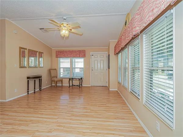 a kitchen with stainless steel appliances granite countertop a table chairs and a refrigerator