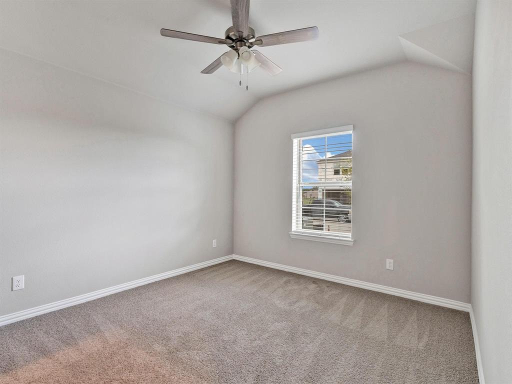 2106 Sandpiper Way Princeton, TX 75407 - Photo 14 of 39 an empty room with a window and a fan