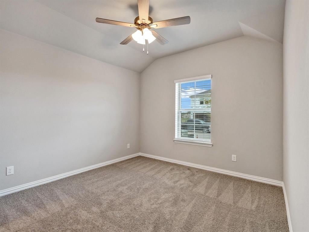2106 Sandpiper Way Princeton, TX 75407 - Photo 15 of 39 an empty room with a window and a fan