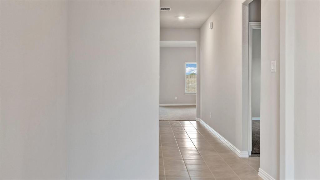 2106 Sandpiper Way Princeton, TX 75407 - Photo 16 of 39 a view of a hallway with wooden floor