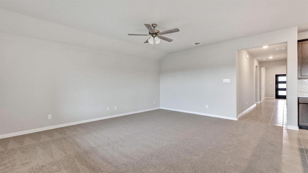 2106 Sandpiper Way Princeton, TX 75407 - Photo 17 of 39 wooden floor in an empty room with a ceiling fan
