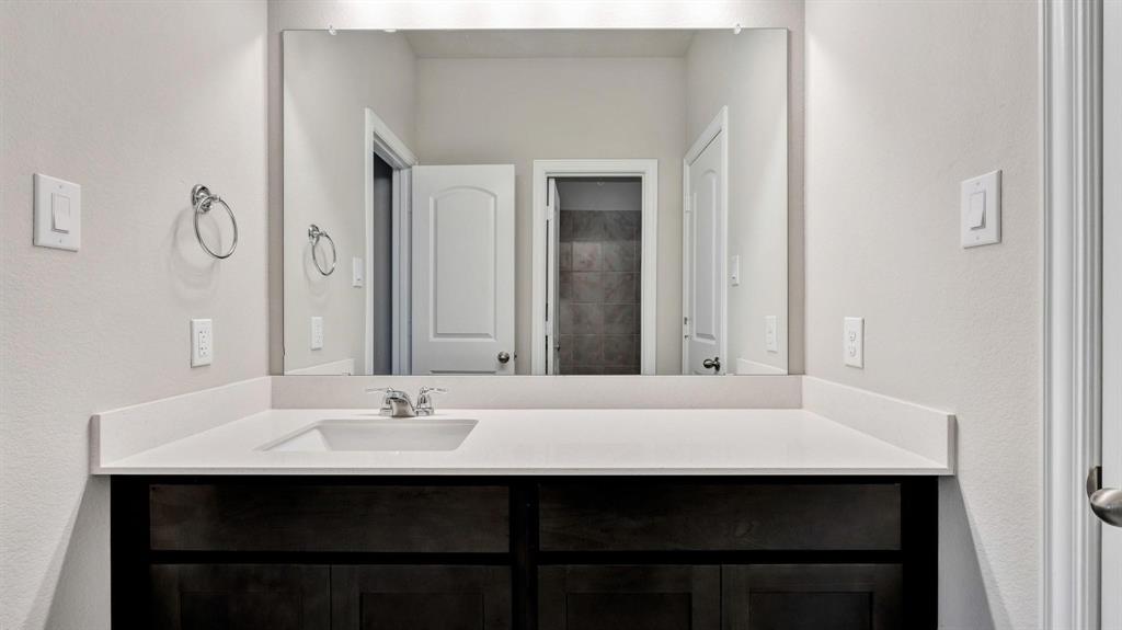 2106 Sandpiper Way Princeton, TX 75407 - Photo 19 of 39 a room with a sink and a mirror
