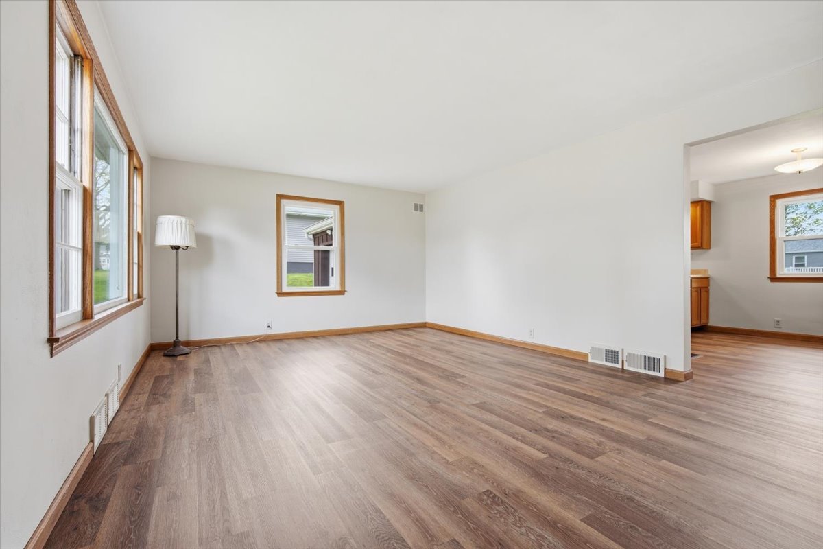 509 Smith Street Roanoke, IL 61561 - Photo 11 of 28 a view of an empty room with wooden floor and a window