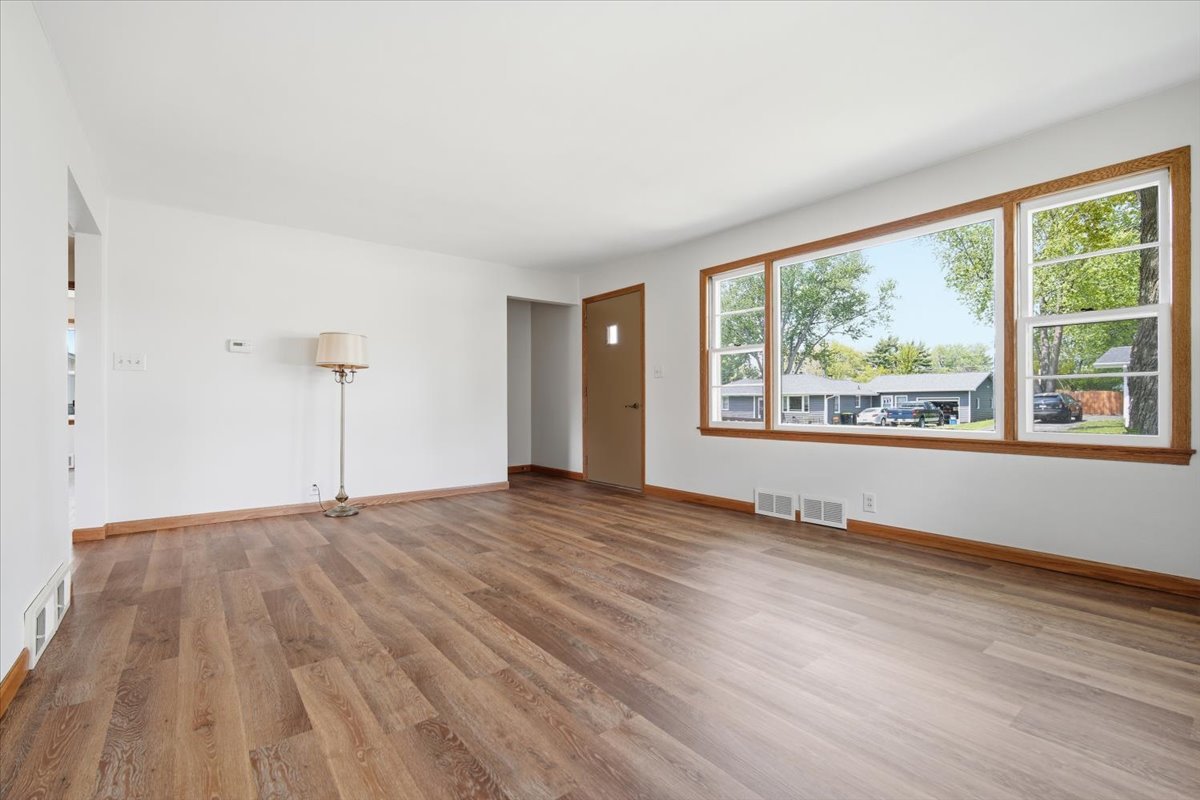 509 Smith Street Roanoke, IL 61561 - Photo 12 of 28 a view of an empty room with wooden floor and a window