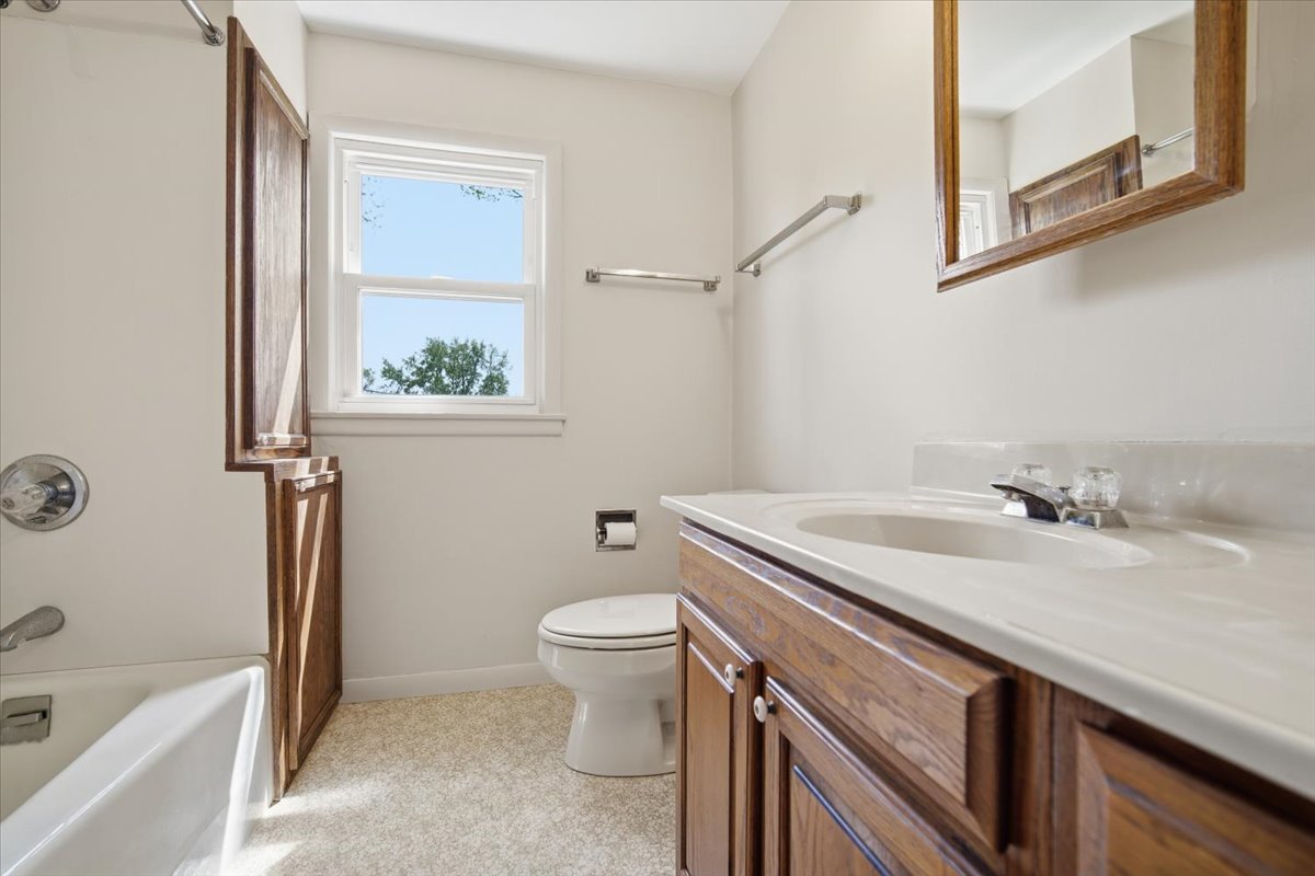 509 Smith Street Roanoke, IL 61561 - Photo 20 of 28 a bathroom with a granite countertop sink toilet and shower