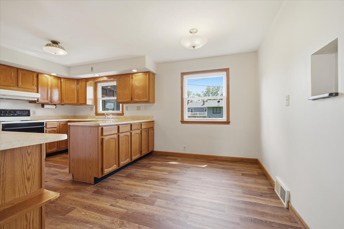 509 Smith Street Roanoke, IL 61561 - Photo 8 of 28 a kitchen with stainless steel appliances granite countertop a stove a sink and a refrigerator