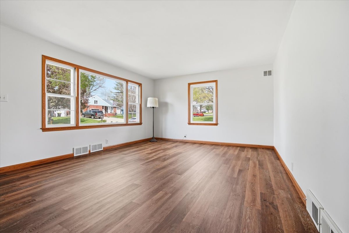 509 Smith Street Roanoke, IL 61561 - Photo 10 of 28 a view of an empty room with wooden floor and a window
