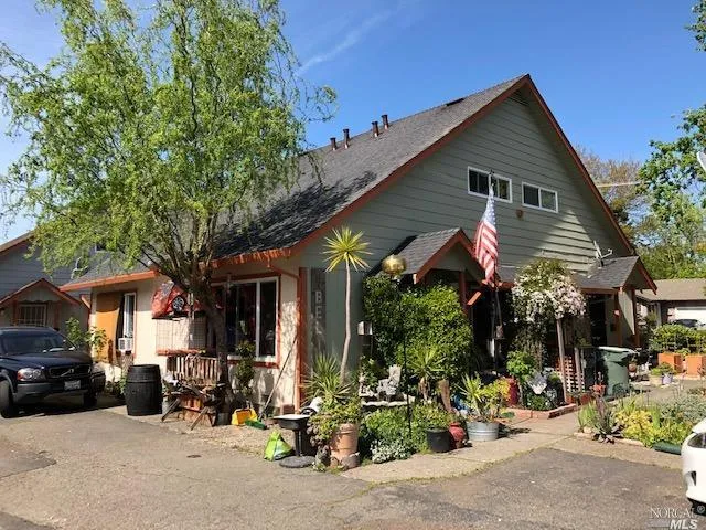 a view of a house with sitting area and potted plants