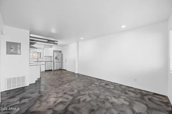 a view of kitchen with refrigerator and wooden floor