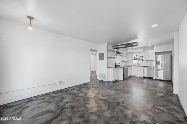 a view of a kitchen with white cabinets