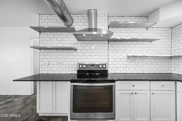 a kitchen with granite countertop white cabinets and black appliances