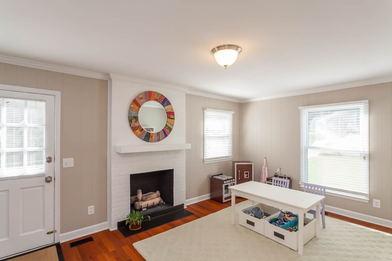 3145 Merrianne Drive Raleigh, NC 27607 - Photo 13 of 25 The bonus room is conveniently located off the kitchen and features a gas fireplace and a side entrance to the outdoors. Bonus Room off Kitchen