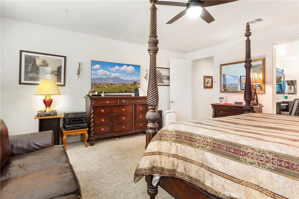 12528 Locke Circle Riverside, CA 92503 - Photo 15 of 46 a bedroom with a bed and wooden floor