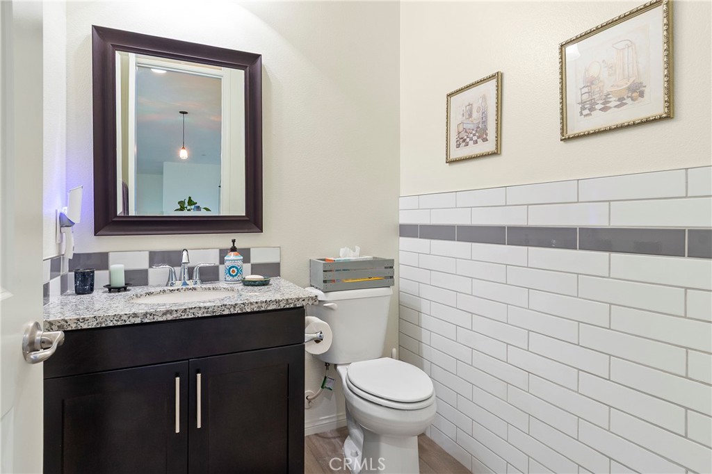 12528 Locke Circle Riverside, CA 92503 - Photo 25 of 46 a bathroom with a toilet sink vanity and mirror