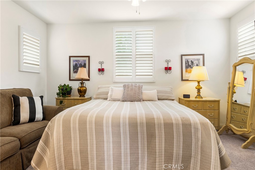 12528 Locke Circle Riverside, CA 92503 - Photo 28 of 46 a bedroom with a large bed and a couch