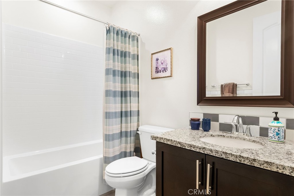 12528 Locke Circle Riverside, CA 92503 - Photo 30 of 46 a bathroom with a granite countertop sink toilet and shower