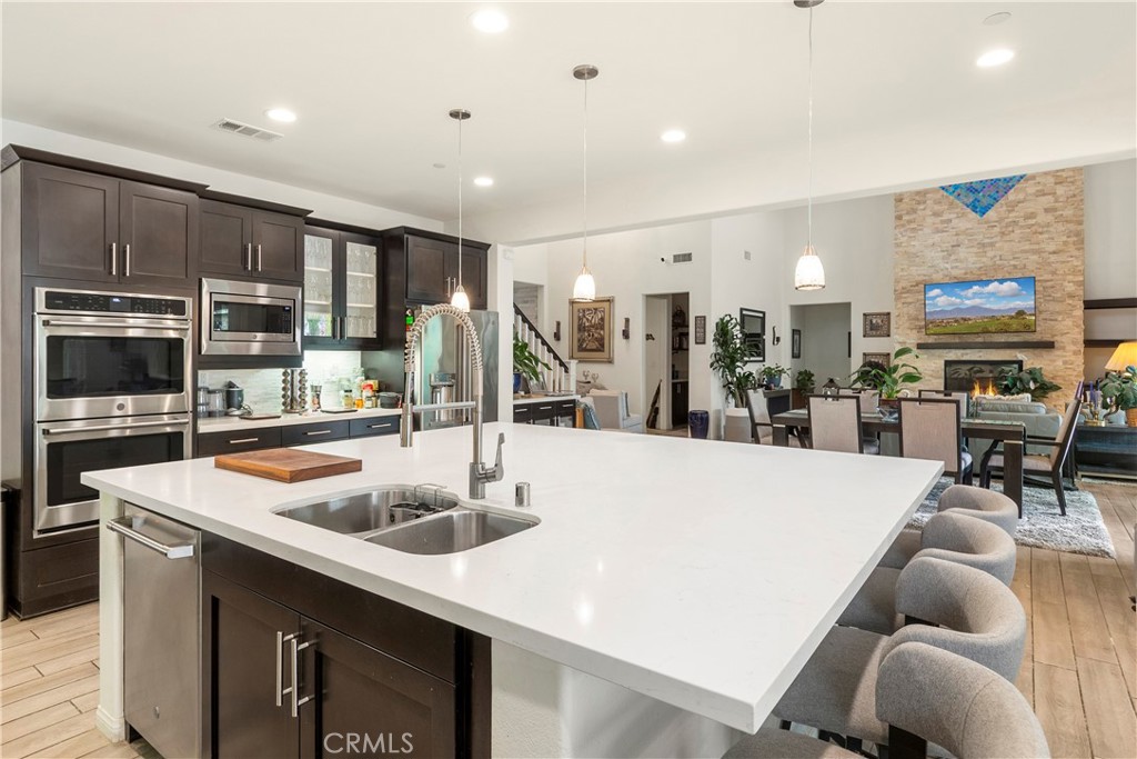 12528 Locke Circle Riverside, CA 92503 - Photo 6 of 46 a kitchen with stainless steel appliances granite countertop a sink and a refrigerator