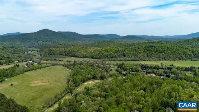 a view of a lush green hillside and houses