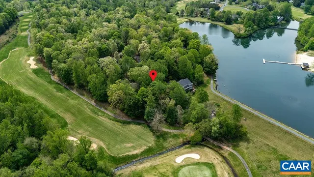 an aerial view of residential houses with outdoor space and trees