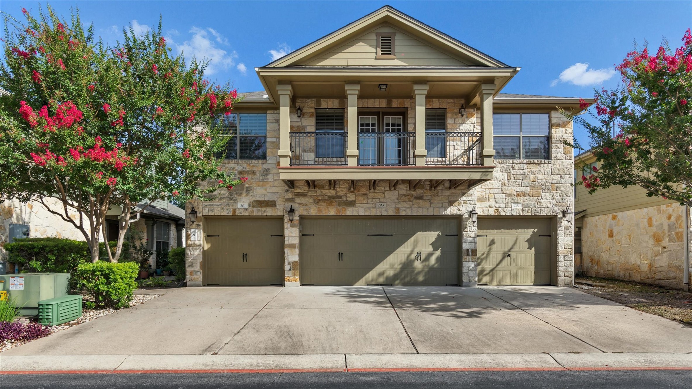 14815 Avery Ranch Boulevard, Unit 2A Austin, TX 78717 - Photo 1 of 27 An attractive stone-clad exterior with a welcoming balcony and convenient garage access.