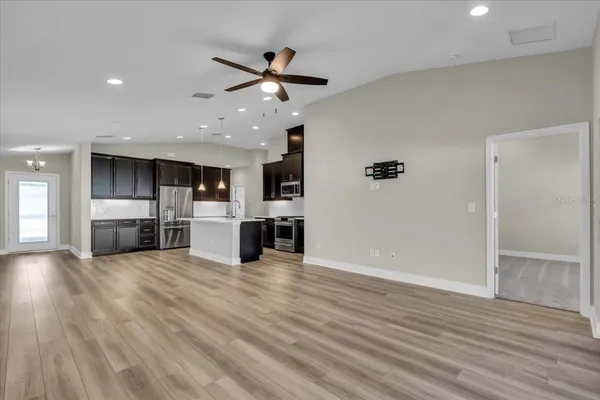 a view of a kitchen with a sink cabinets and wooden floor