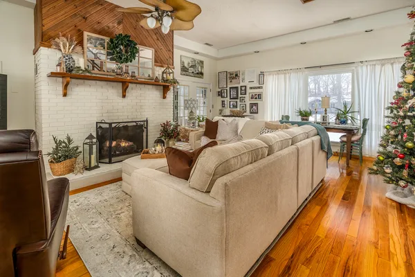 a living room with furniture and wooden floor