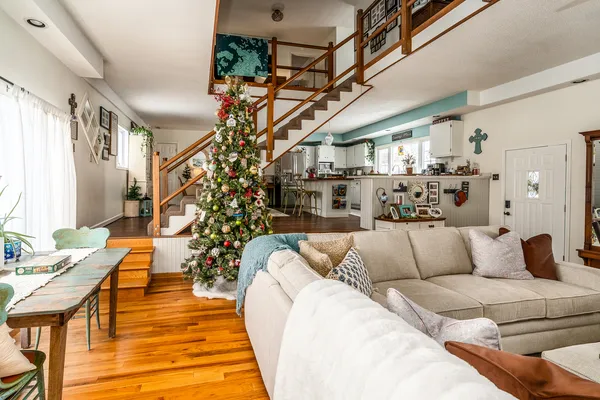 a dining area with stainless steel appliances granite countertop a dining table chairs refrigerator and sink