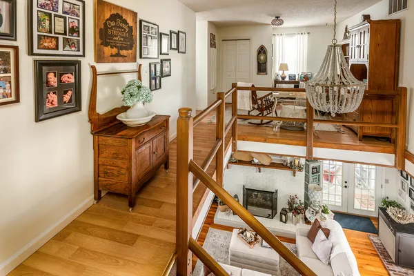 a bedroom with bed and a chandelier