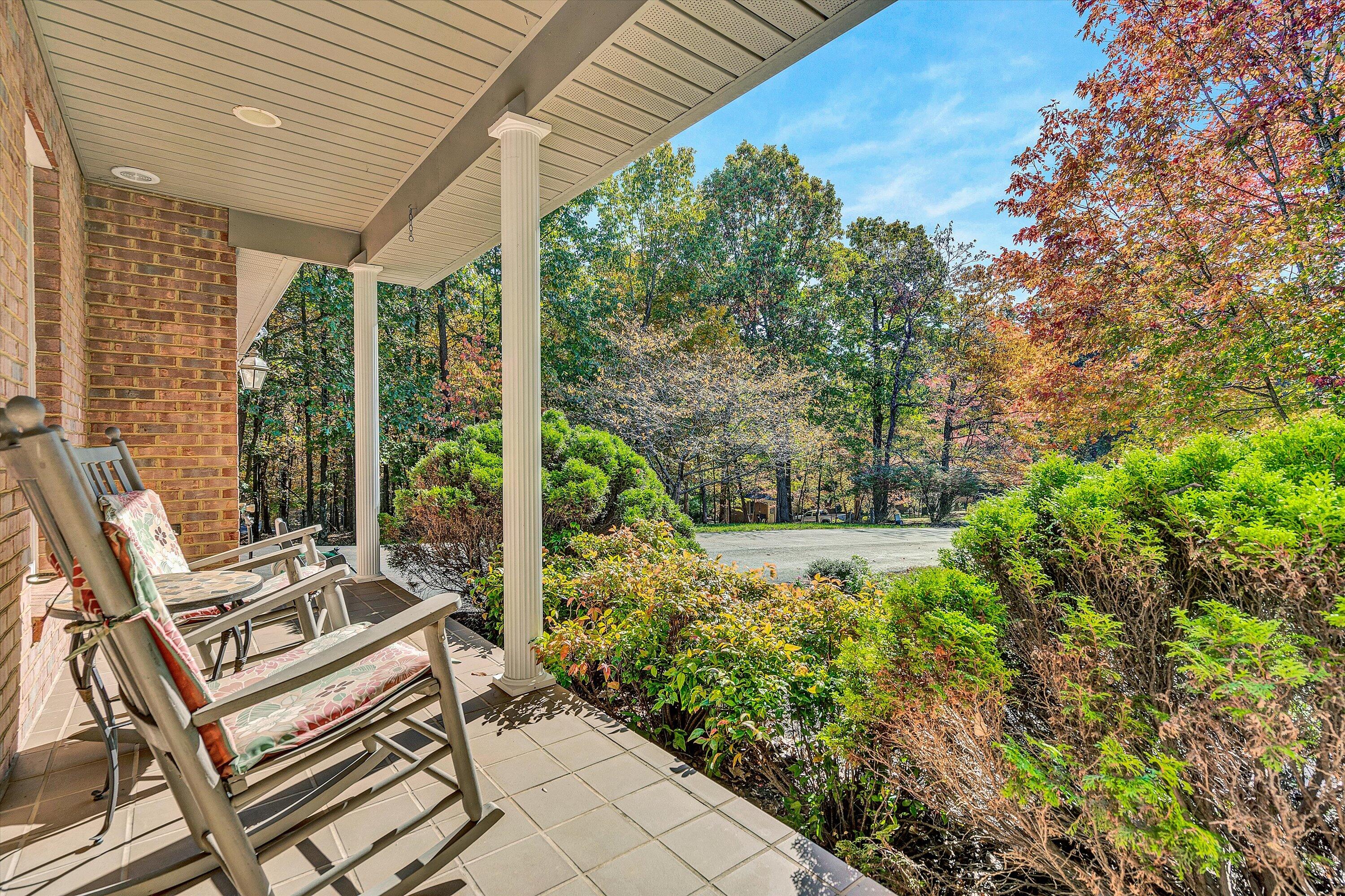 526 Stonebridge Drive Blue Ridge, VA 24064 - Photo 3 of 35 a view of a patio with table and chairs and potted plants