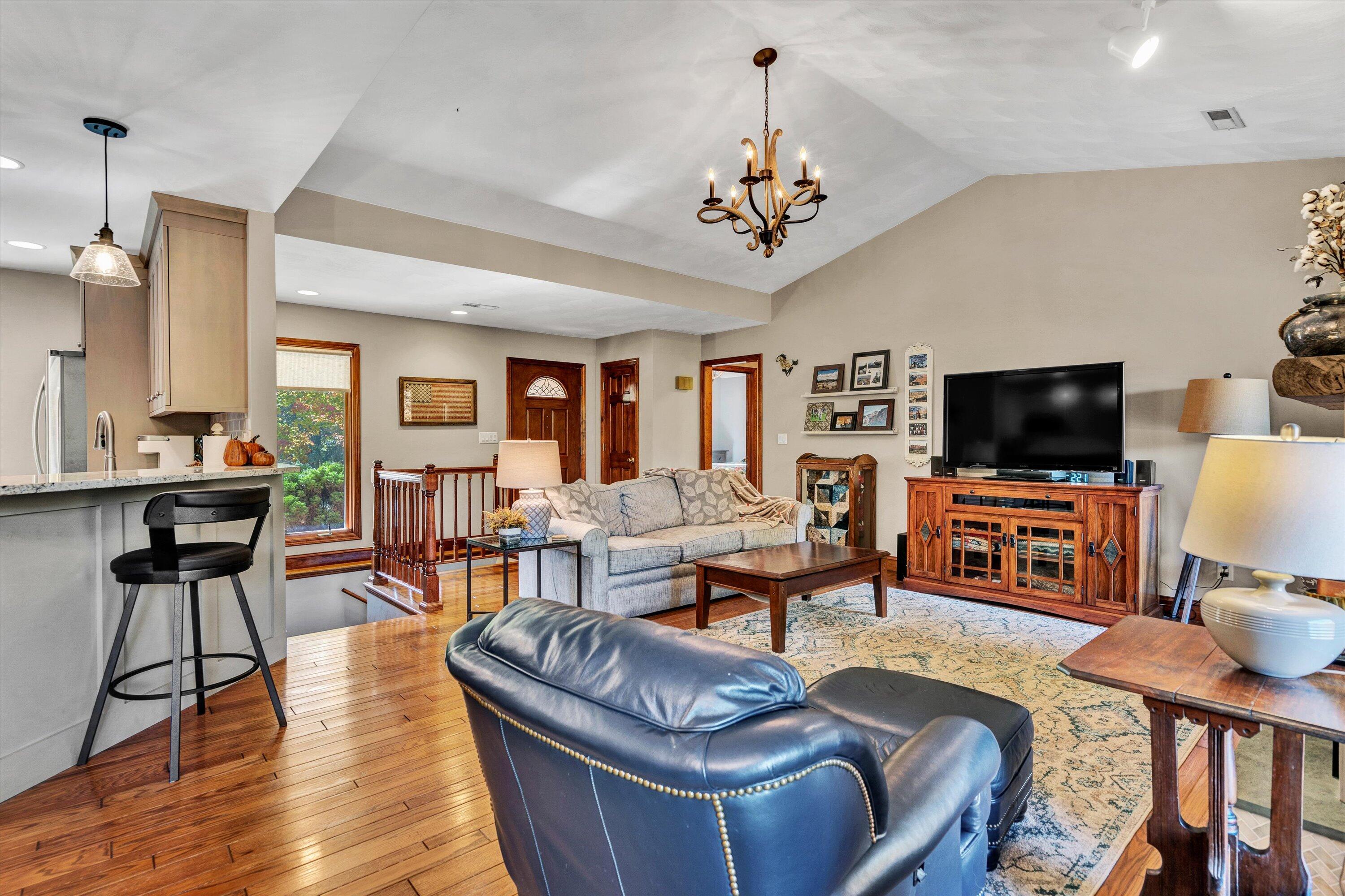 526 Stonebridge Drive Blue Ridge, VA 24064 - Photo 5 of 35 a living room with furniture a flat screen tv and kitchen view