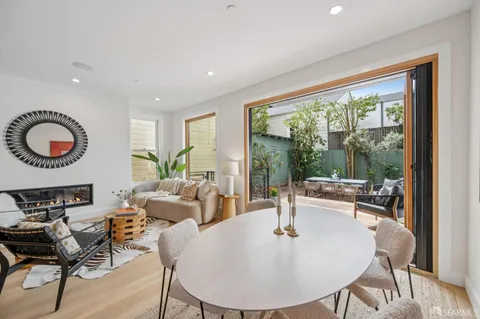 a view of two chairs and table in the balcony