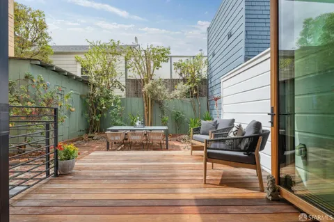 a view of a patio with table and chairs and potted plants