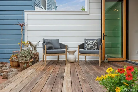 a outdoor space with a couch and potted plants