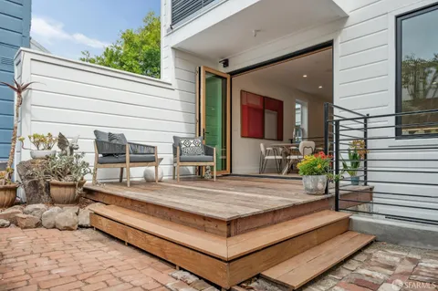 a bedroom with furniture and a large window