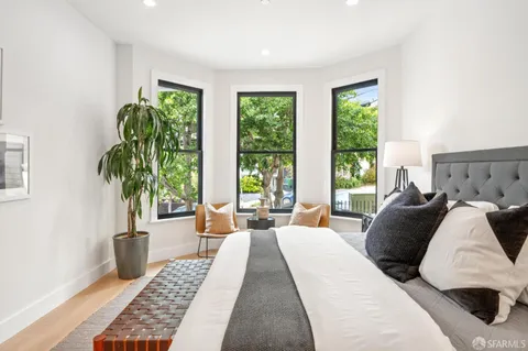 a bedroom with a large bed and a window