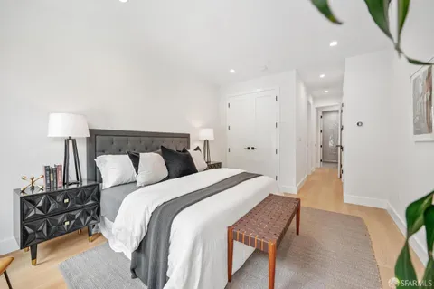 a bathroom with a bathtub and a potted plant