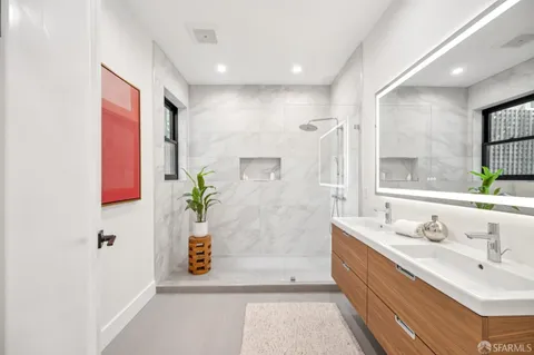 a bathroom with a sink a toilet and shower