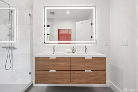 a bathroom with a sink mirror vanity and toilet