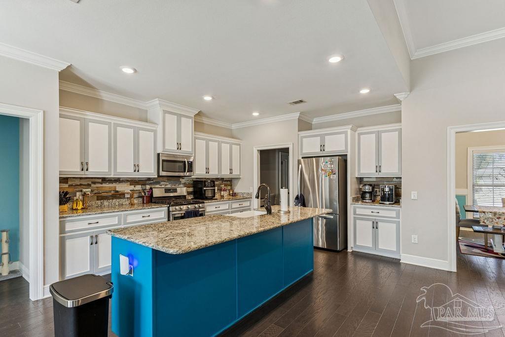 a kitchen with refrigerator a sink and cabinets