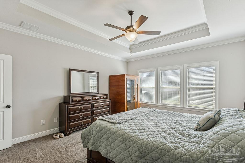 1555 Cadence Loop Cantonment, FL 32533 - Photo 16 of 34 a bedroom with a bed dresser and a window