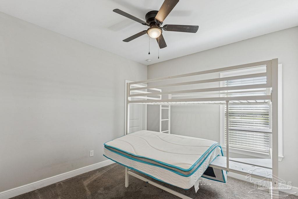 1555 Cadence Loop Cantonment, FL 32533 - Photo 28 of 34 a room with ceiling fan