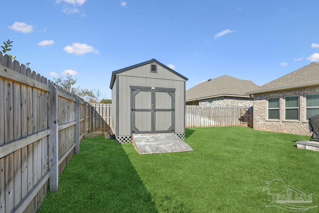 1555 Cadence Loop Cantonment, FL 32533 - Photo 34 of 34 a front view of a house with a yard