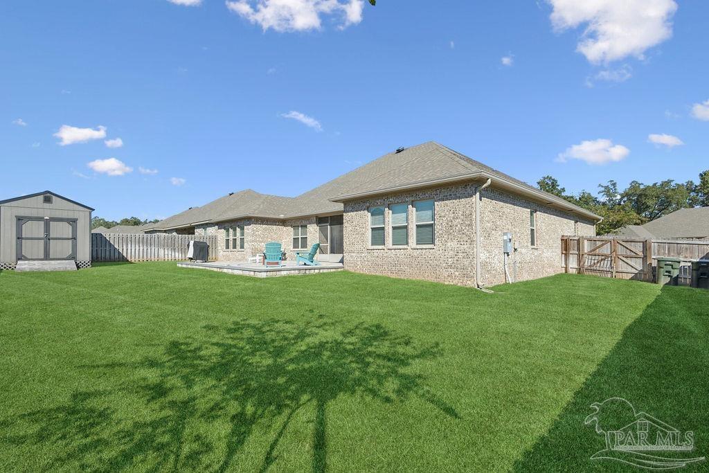 1555 Cadence Loop Cantonment, FL 32533 - Photo 5 of 34 a view of an house with backyard space and garden