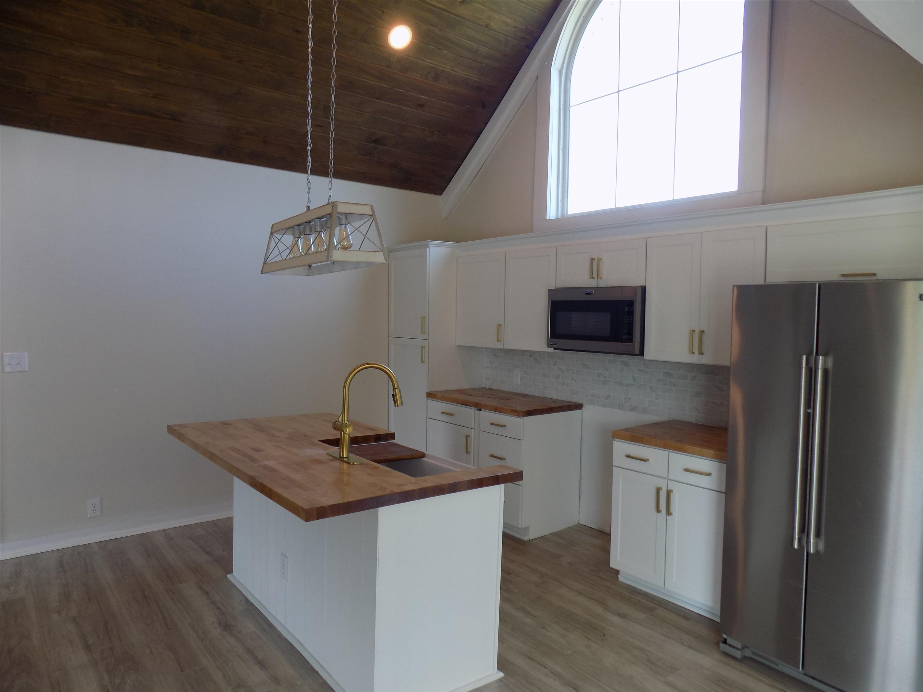 821 Greys Mill Road Louisburg, NC 27549 - Photo 11 of 33 a kitchen with stainless steel appliances granite countertop a sink a microwave a refrigerator and a stove